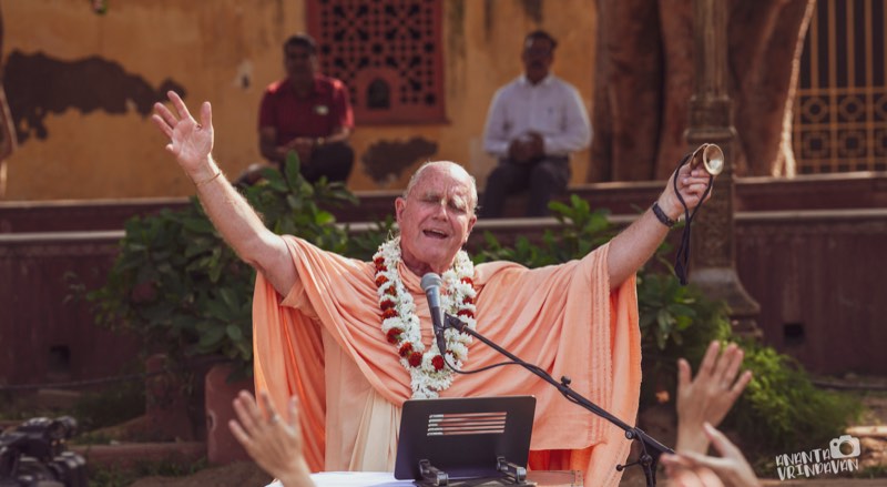 Indradyumna Swami with arms raised in kirtan